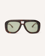 Front view of chunky acetate frame in an aviator shape. Tortoise frame with green lenses.