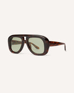 Angled view of chunky acetate frame in an aviator shape. You can really see the thickness of the frame. Tortoise frame with green lenses.