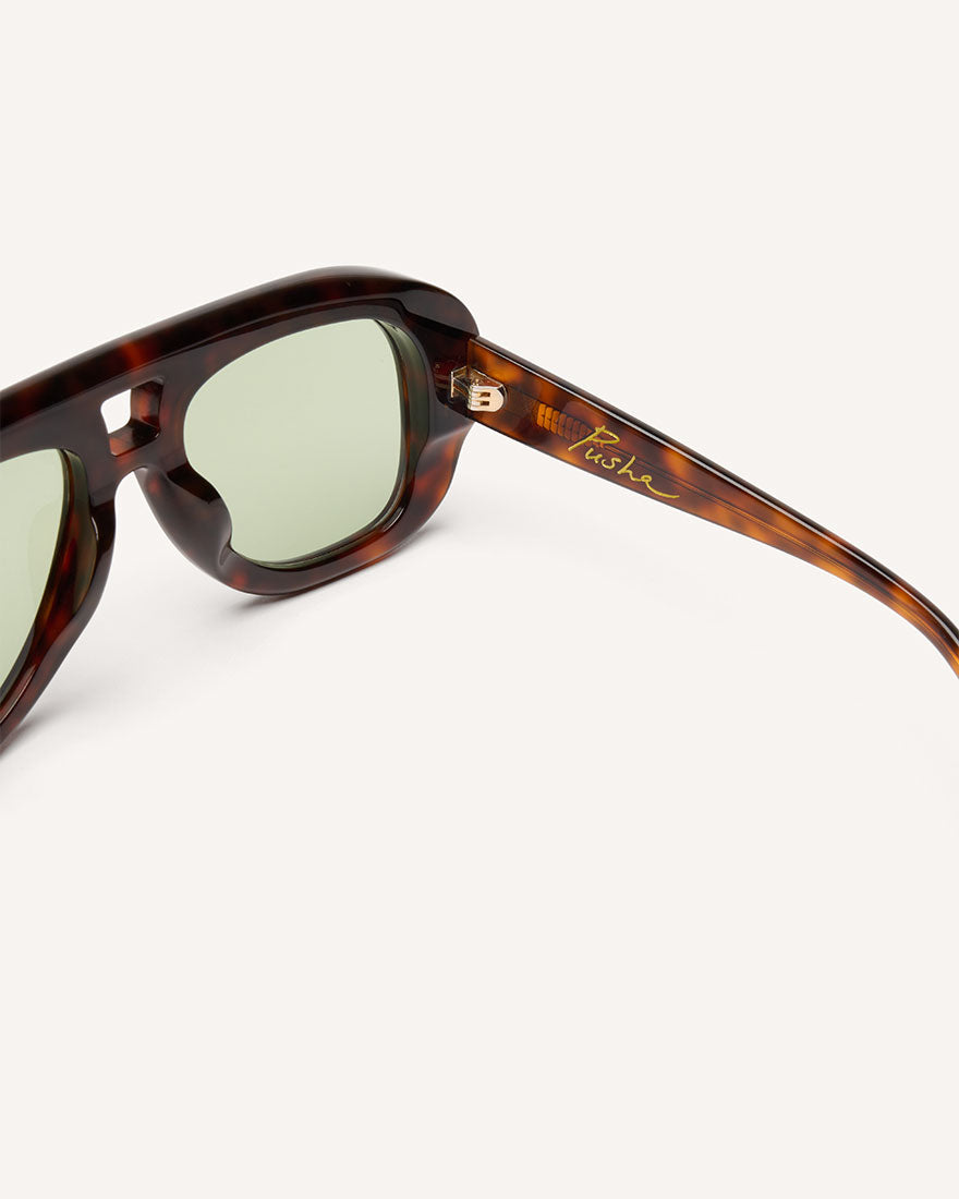 Inside view of chunky acetate frame in an aviator shape. Tortoise frame with green lenses.