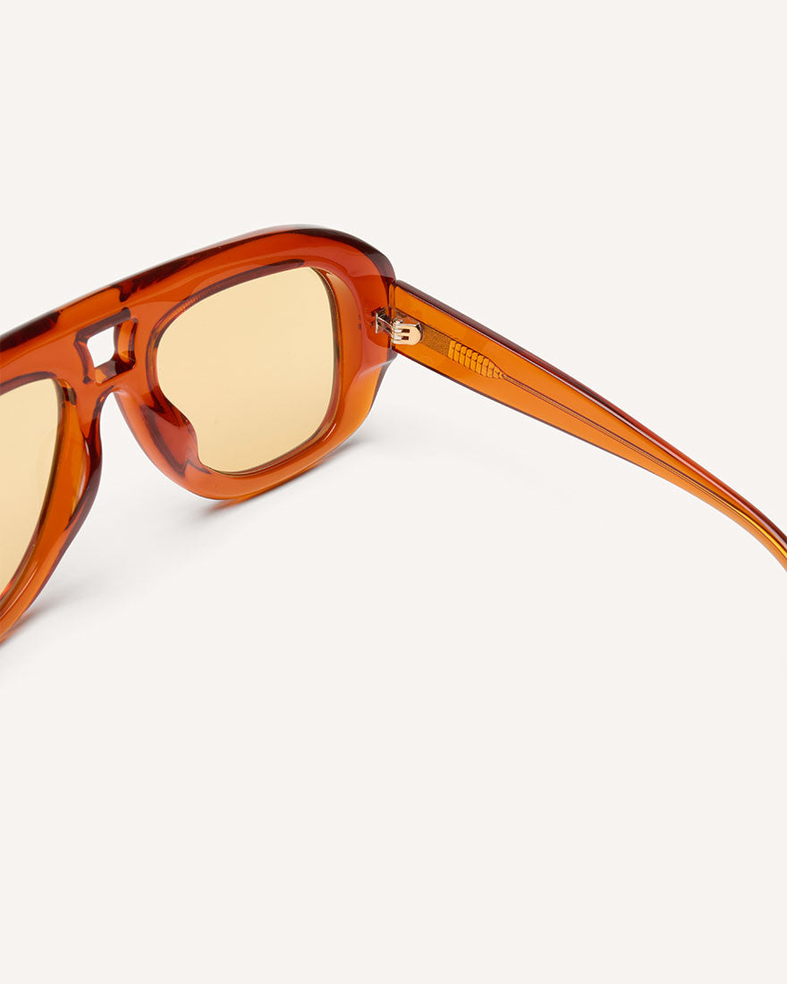 inside view of chunky acetate frame in an aviator shape. Orange frame with yellow lenses.
