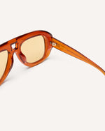 inside view of chunky acetate frame in an aviator shape. Orange frame with yellow lenses.