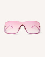 front view of shield frame. The metal bridge is on the bottom of the continuous lens, thus its name, reverse. pink faded lens and pink metal