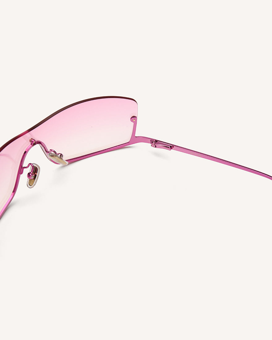 inside view of shield frame. The metal bridge is on the bottom of the continuous lens, thus its name, reverse. pink faded lens and pink metal