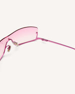inside view of shield frame. The metal bridge is on the bottom of the continuous lens, thus its name, reverse. pink faded lens and pink metal