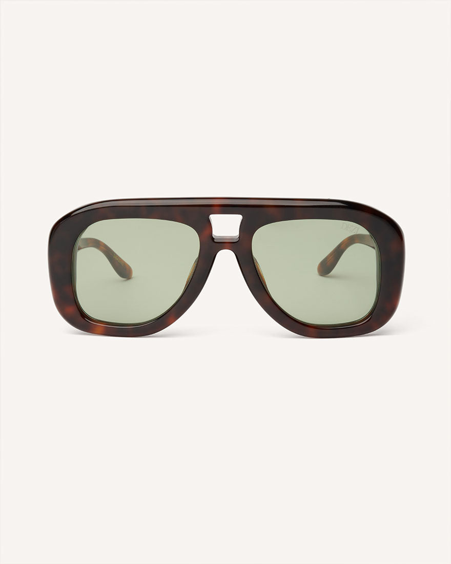 Front view of chunky acetate frame in an aviator shape. Tortoise frame with green lenses. 