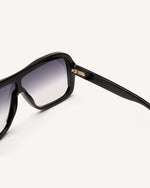 Inside view of stylish acetate sunglasses with a modern design, featuring a sleek black frame and subtly faded black lens.