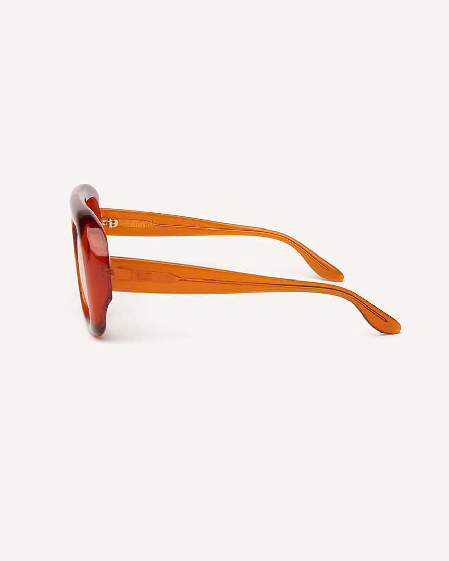 side view of chunky acetate frame in an aviator shape. Orange frame with yellow lenses. 