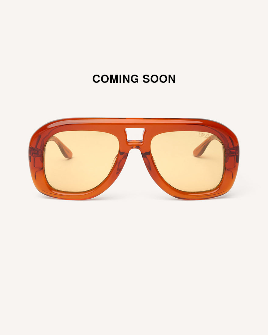 front view of chunky acetate frame in an aviator shape. Orange frame with yellow lenses. 