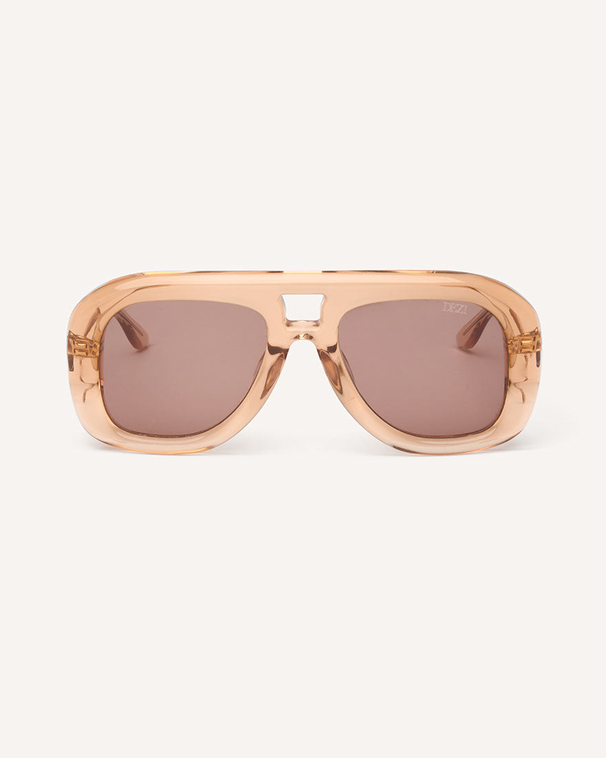 Front view of chunky acetate frame in an aviator shape. Peach Frame with brown lenses.