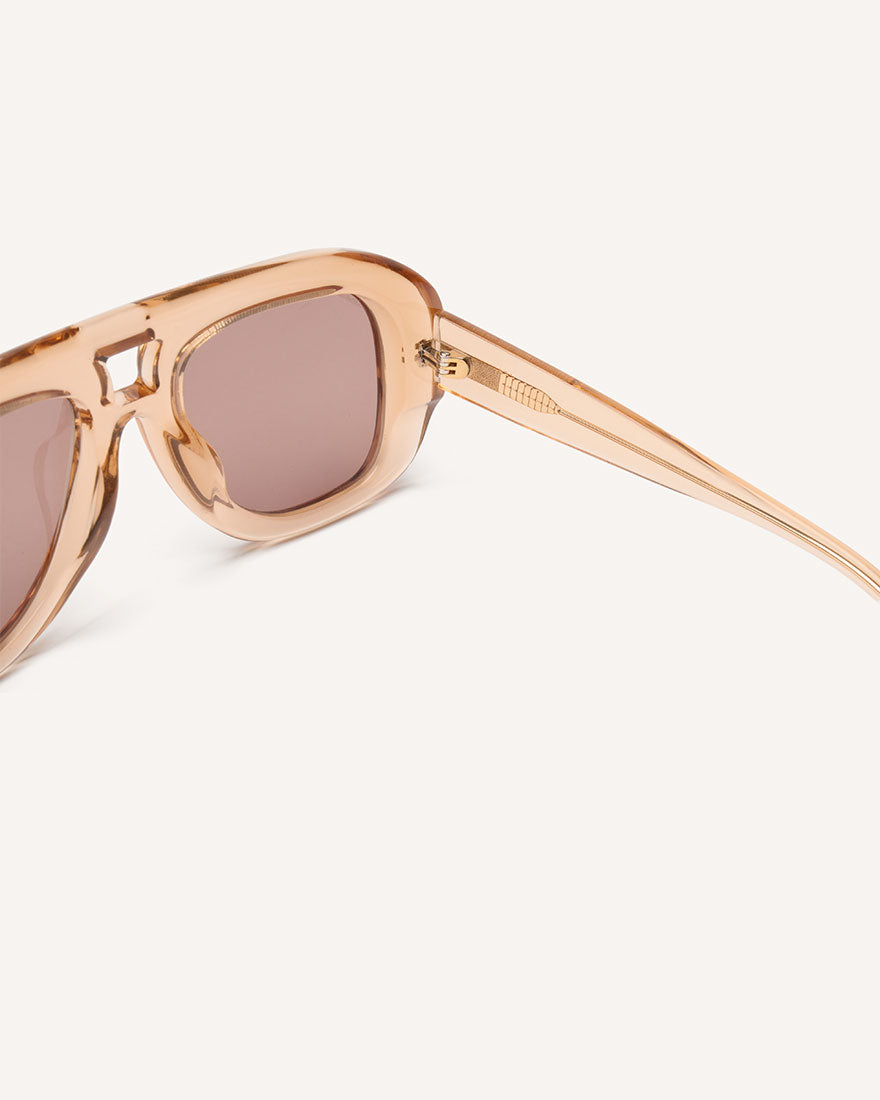 Inside view of chunky acetate frame in an aviator shape. Peach Frame with brown lenses.