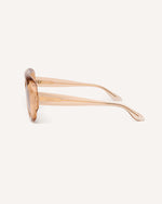 side view of chunky acetate frame in an aviator shape. Peach Frame with brown lenses.