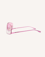 side view of shield frame. The metal bridge is on the bottom of the continuous lens, thus its name, reverse. pink faded lens and pink metal